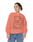 Woman wearing a coral sweatshirt with 'Sweater Weather Forever' text and leaf design on a white background