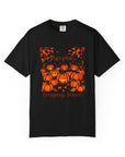 Black t-shirt with orange pumpkin design on a white background
