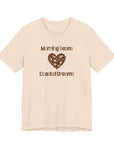 Beige t-shirt with 'Morning Beans Coastal Dreams' text and heart-shaped design on a white background