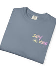 Folded gray t-shirt with a small logo on a white background