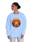 Woman wearing a light blue sweatshirt with a 'Cozy Campfire' design on a white background