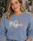Woman wearing a blue sweatshirt with 'BOY Mama' text in a home setting