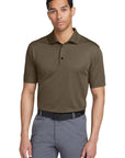 Man wearing a brown polo shirt and gray pants on a white background