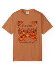 Brown t-shirt with pumpkin design and text on a white background