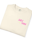 Folded cream-colored t-shirt with 'Salty Vibes' text in pink on a white background