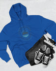 Blue hoodie with a logo, black bag, and black sneakers on a light gray background