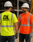 Two construction workers in high-visibility shirts at a construction site.