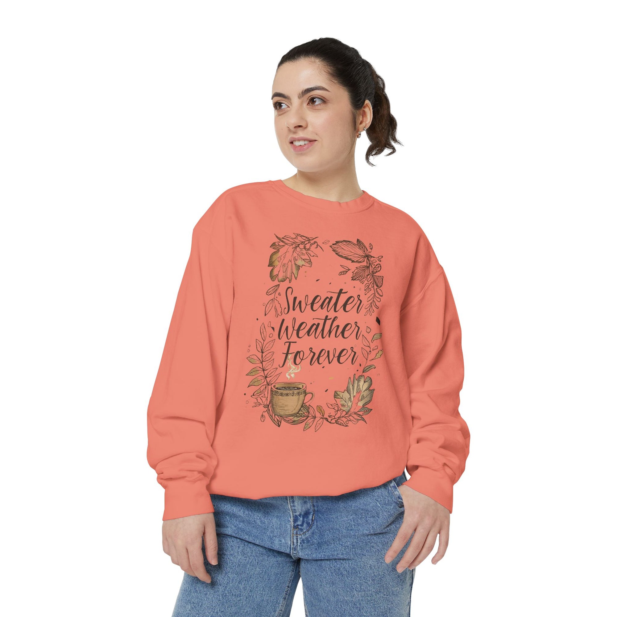 Woman wearing a coral sweatshirt with &#39;Sweater Weather Forever&#39; text and leaf design on a white background