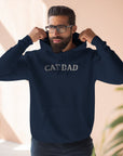 Man wearing a navy blue hoodie with 'CAT DAD' text, standing indoors.