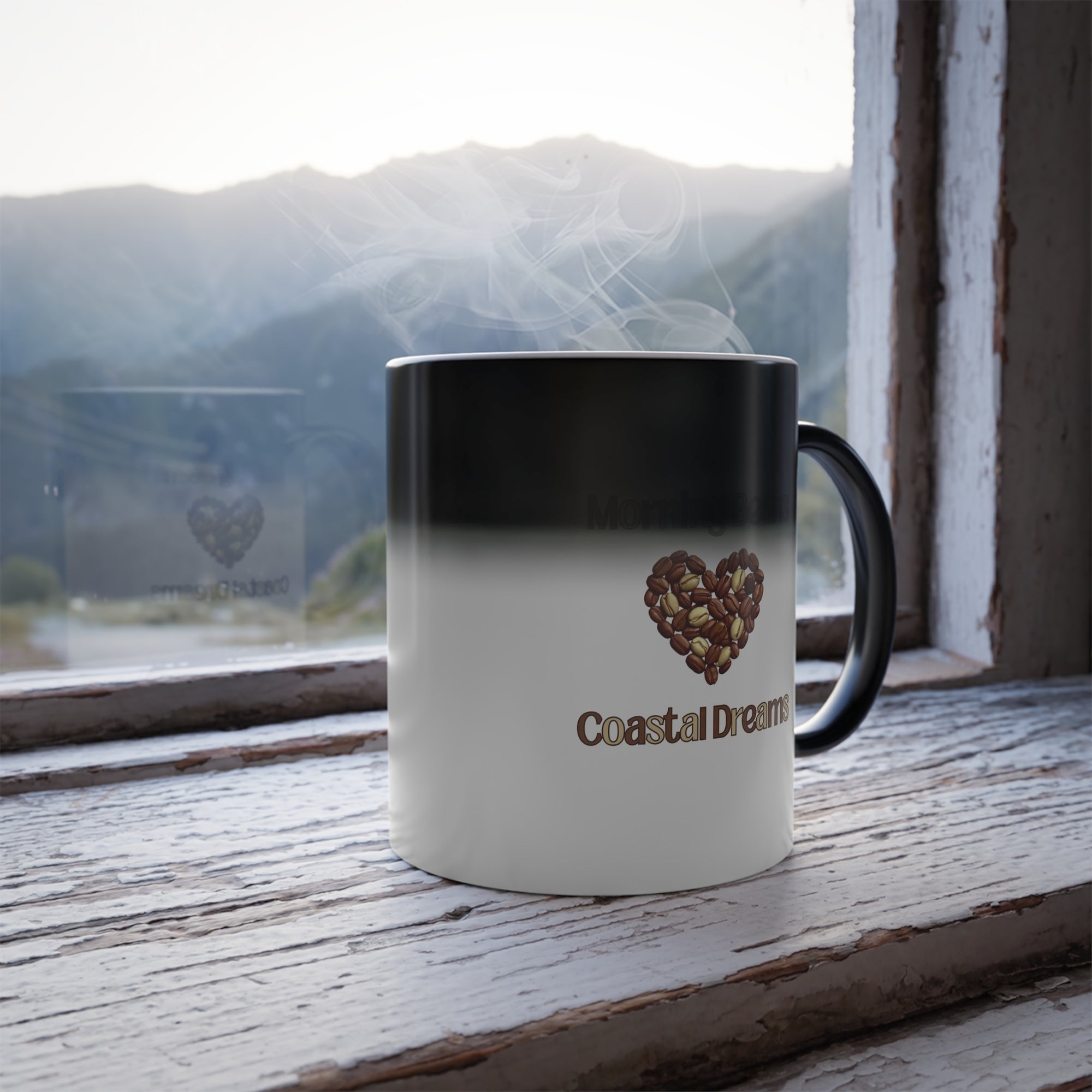 Mug with 'Coastal Dreams' logo on a windowsill with a mountain view