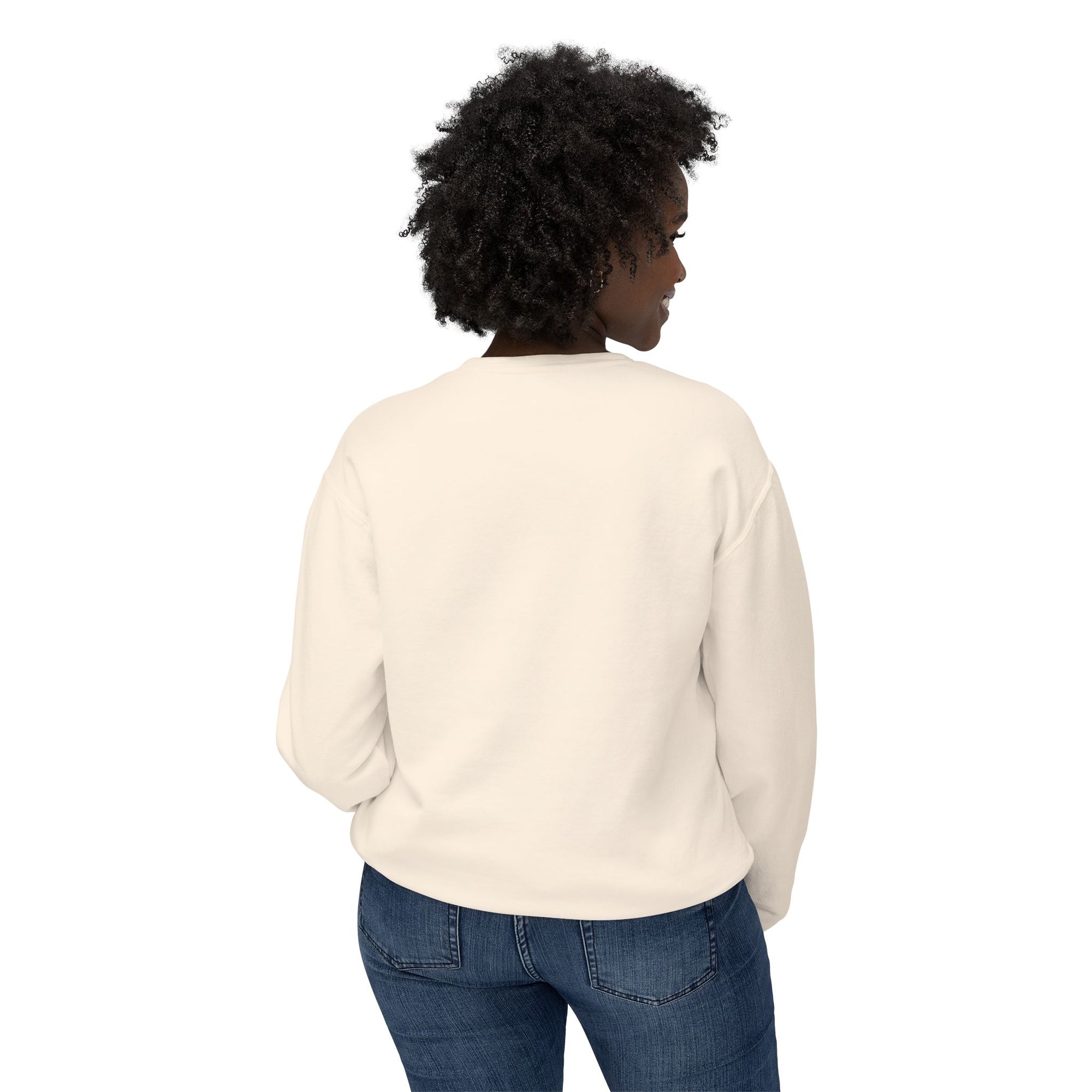 Person wearing a cream sweater and blue jeans on a white background