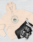 Beige hoodie with a customizable logo design, black pants, and black sneakers on a light gray background