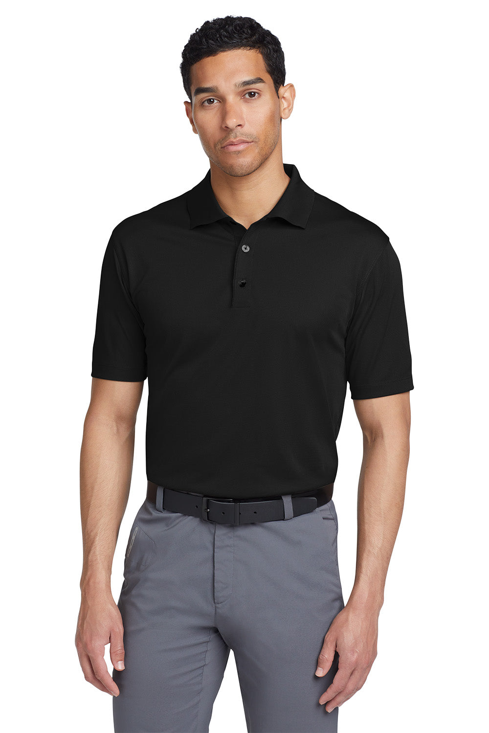 Man wearing a black polo shirt and gray pants on a white background