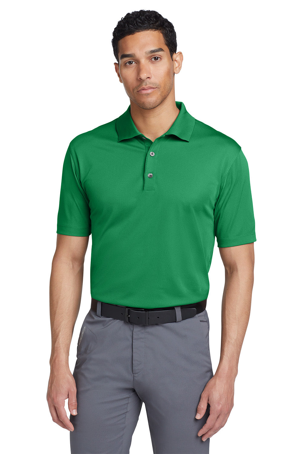 Man wearing a green polo shirt and gray pants on a white background