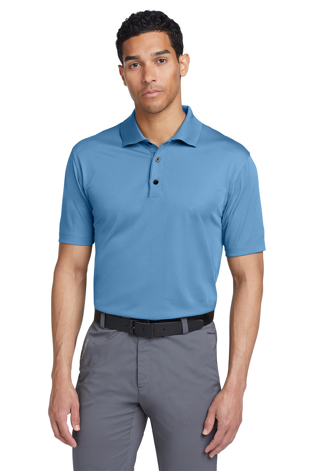 Man wearing a blue polo shirt and gray pants on a white background