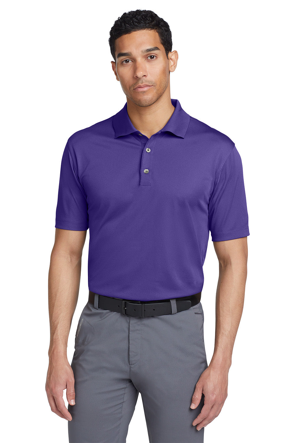 Man wearing a purple polo shirt and gray pants on a white background