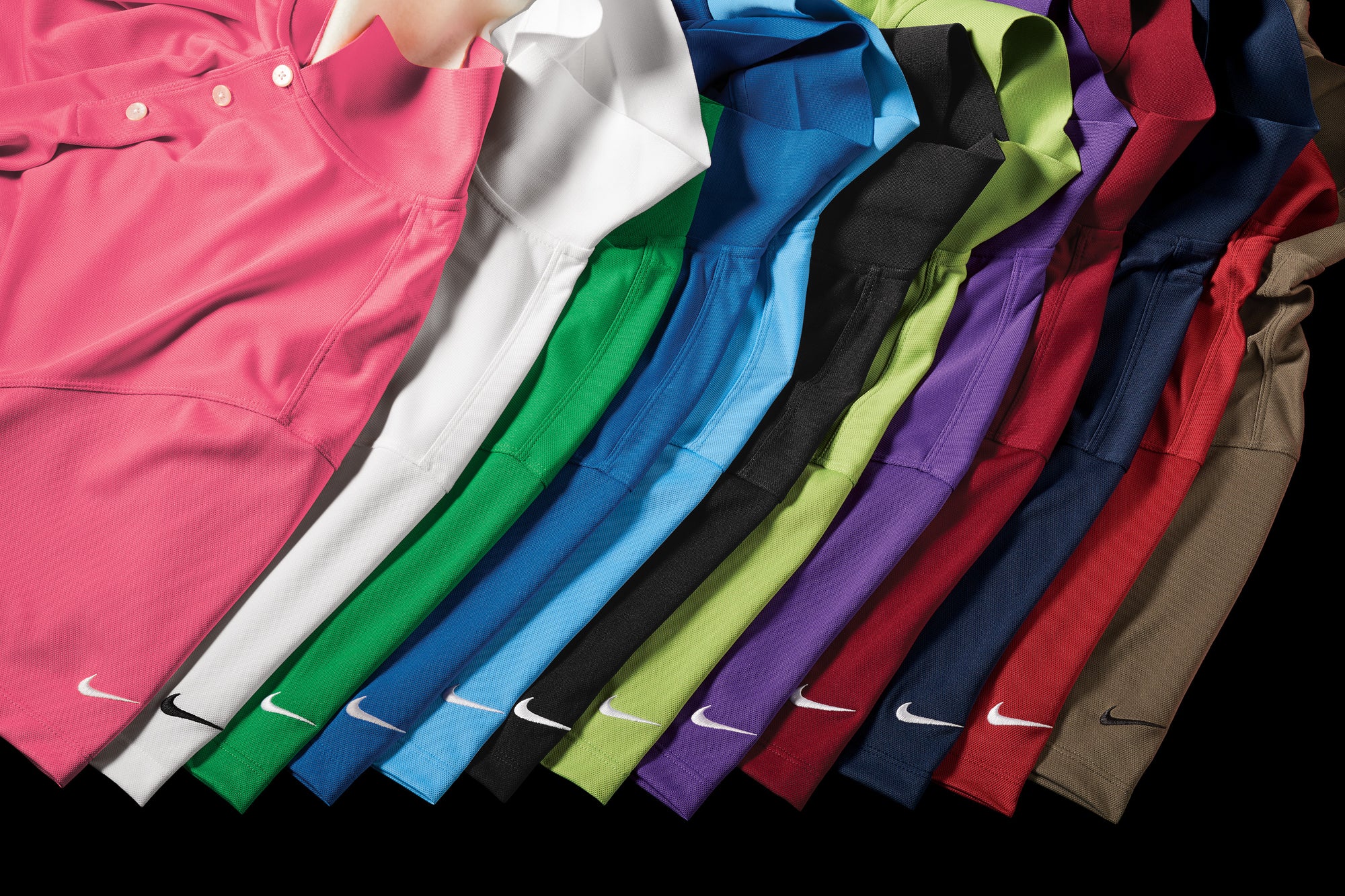 Row of Nike polo shirts in various colors on a black background