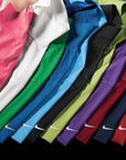 Row of Nike polo shirts in various colors on a black background