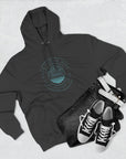 Black hoodie with a design on it, black jeans, and black sneakers on a light gray background