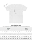 White t-shirt with measurement lines and a size chart for Next Level 3600 shirts.