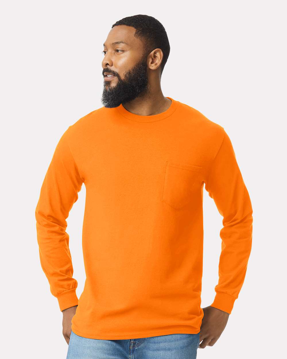 Man wearing an orange long-sleeve shirt against a plain background