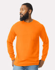 Man wearing an orange long-sleeve shirt against a plain background
