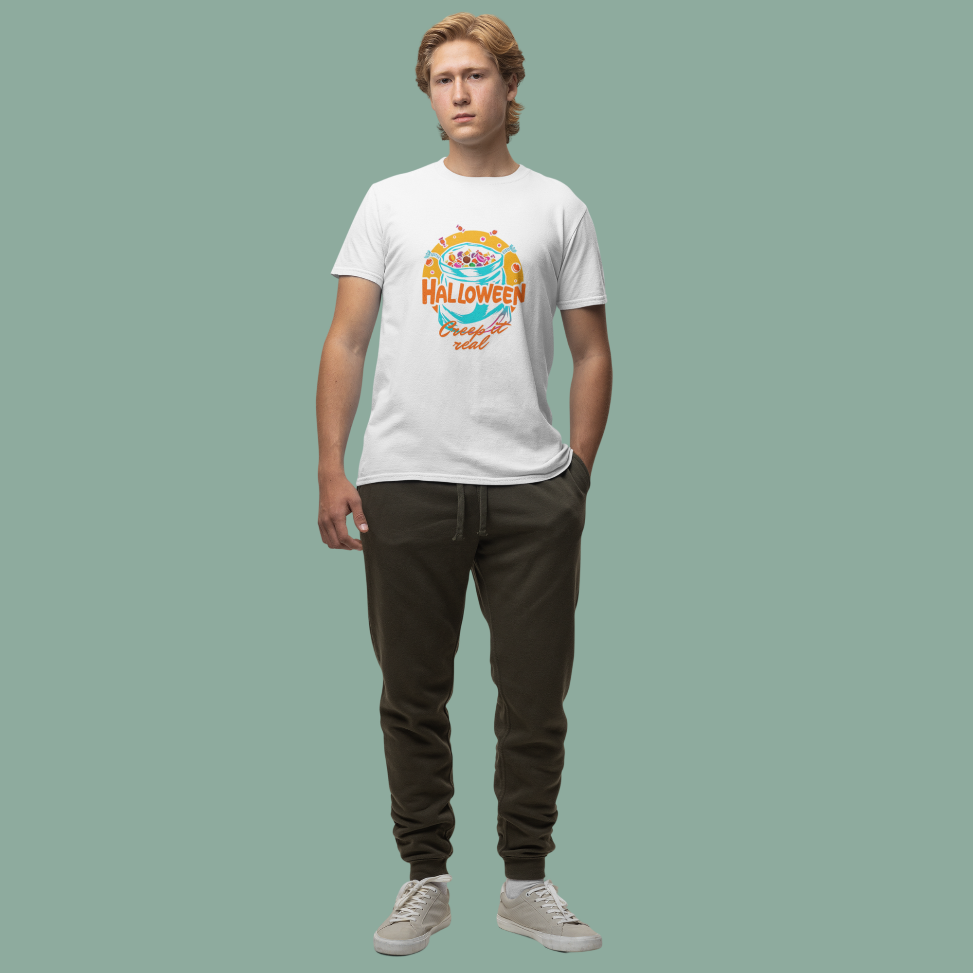 Person wearing a white t-shirt with a colorful graphic design on a plain background