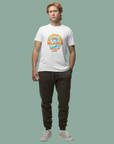 Person wearing a white t-shirt with a colorful graphic design on a plain background