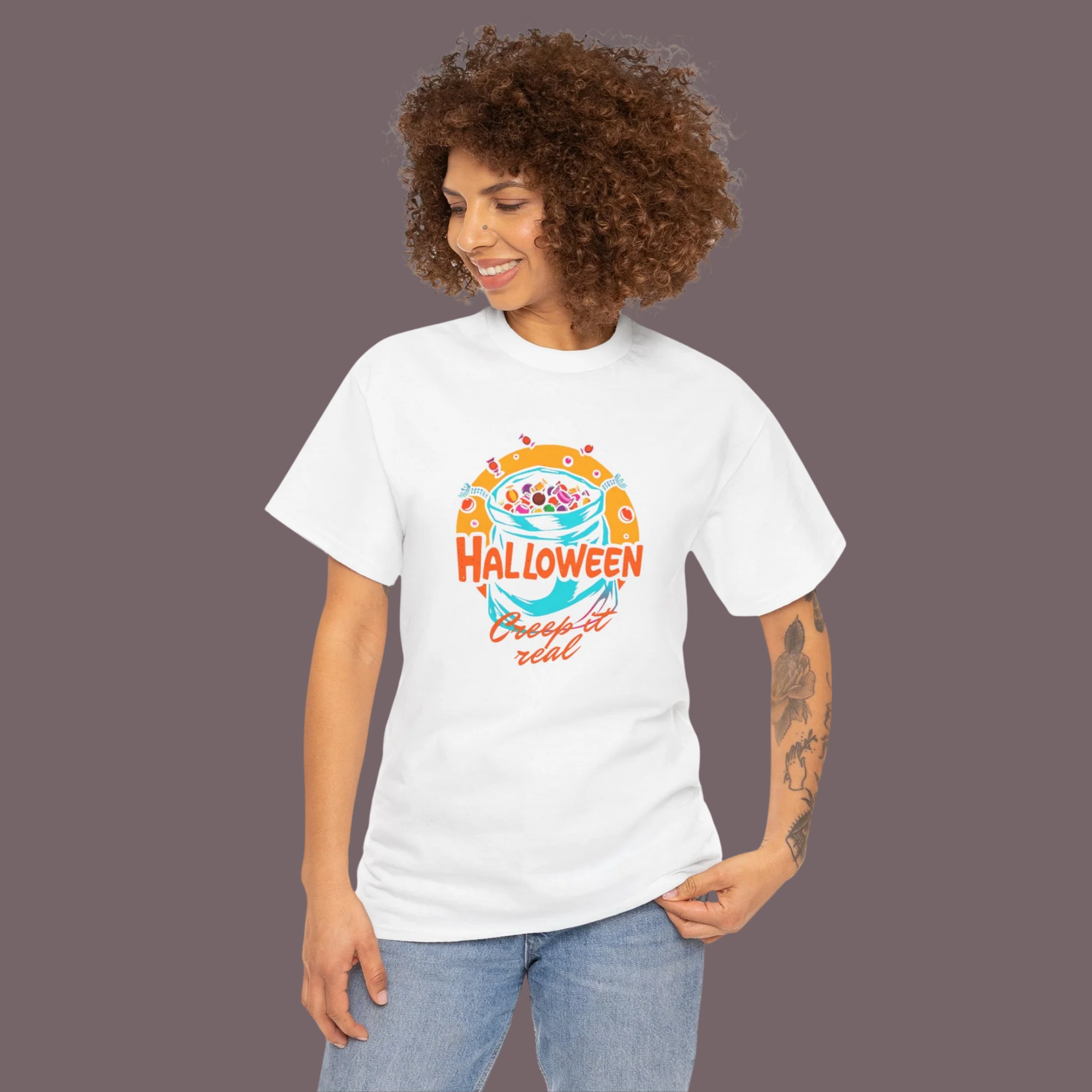 Woman wearing a white t-shirt with a colorful 'Halloween Creepy or Treat' design on a gray background